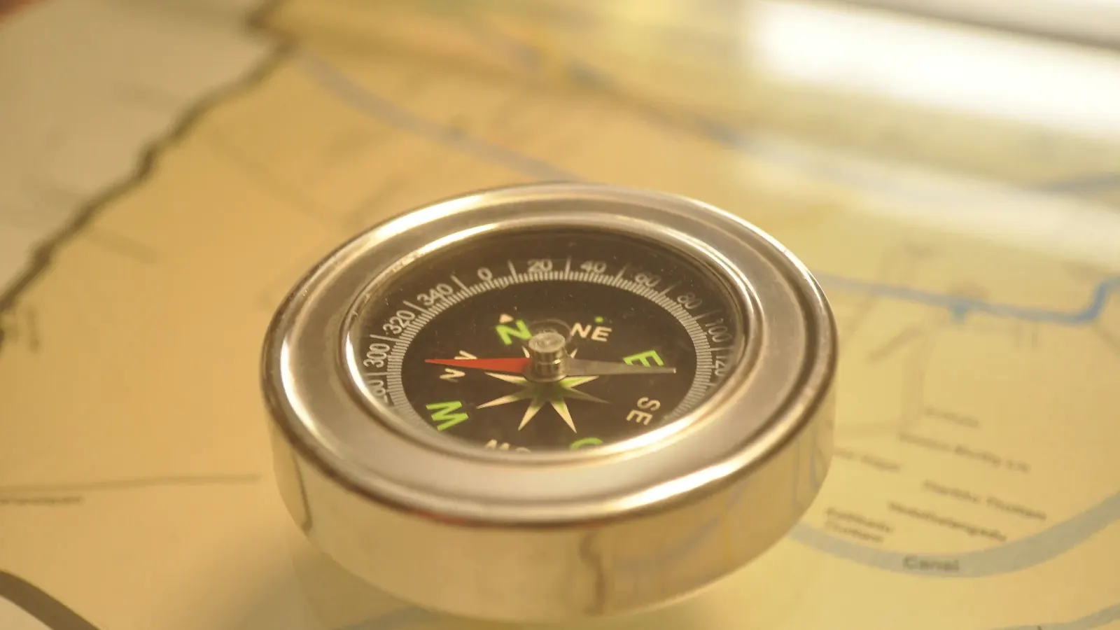 A compass resting on a paper map