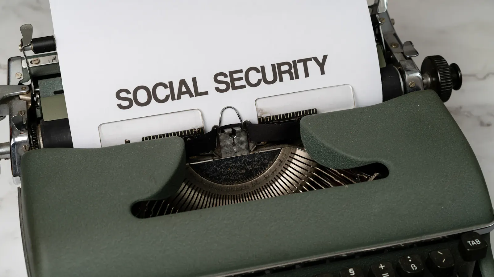 A typewriter with a sheet of paper reading Social Security